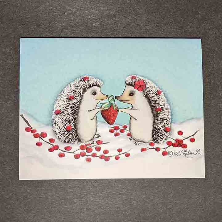 A greeting card showing two hedgehogs sharing a strawberry