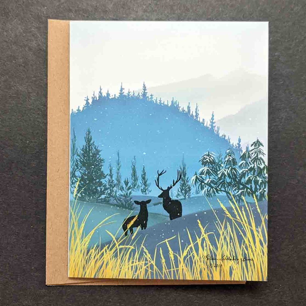 A greeting card of two deers standing in the mountains