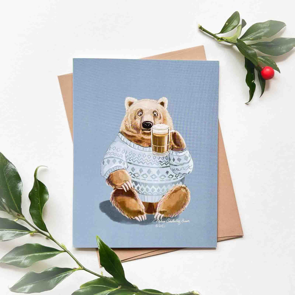 a greeting card featuring a brown bear raising a mug of beer to say cheers