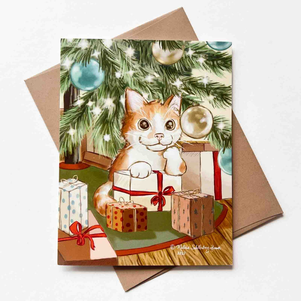 A holiday card featuring an orange cat sitting under a Christmas tree surrounded by presents