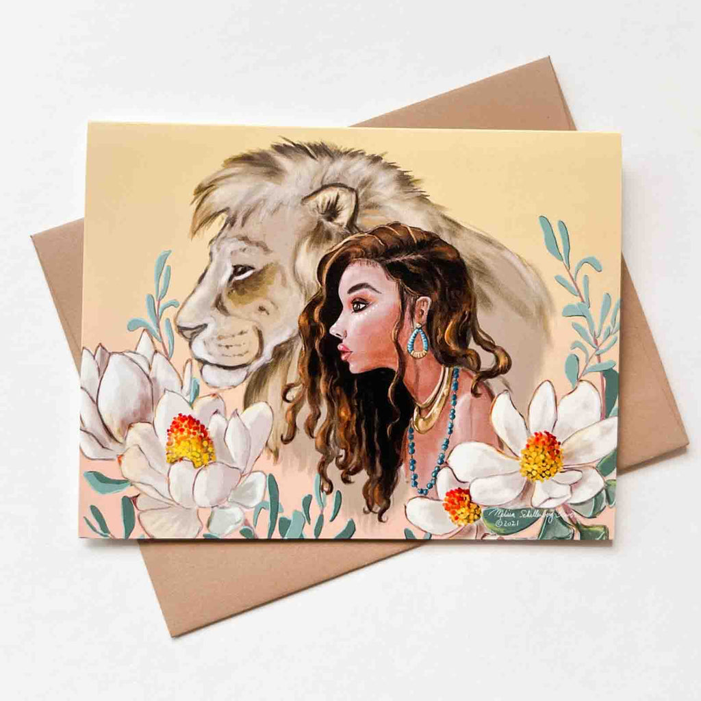 a beautiful notecard featuring a girl and her lion best friend surrounded by flowers