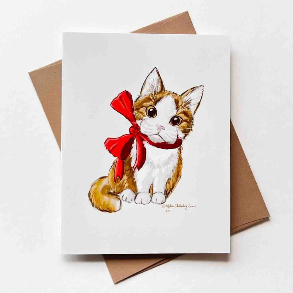 This notecard features a cute cat wearing a red bow is shown in this card