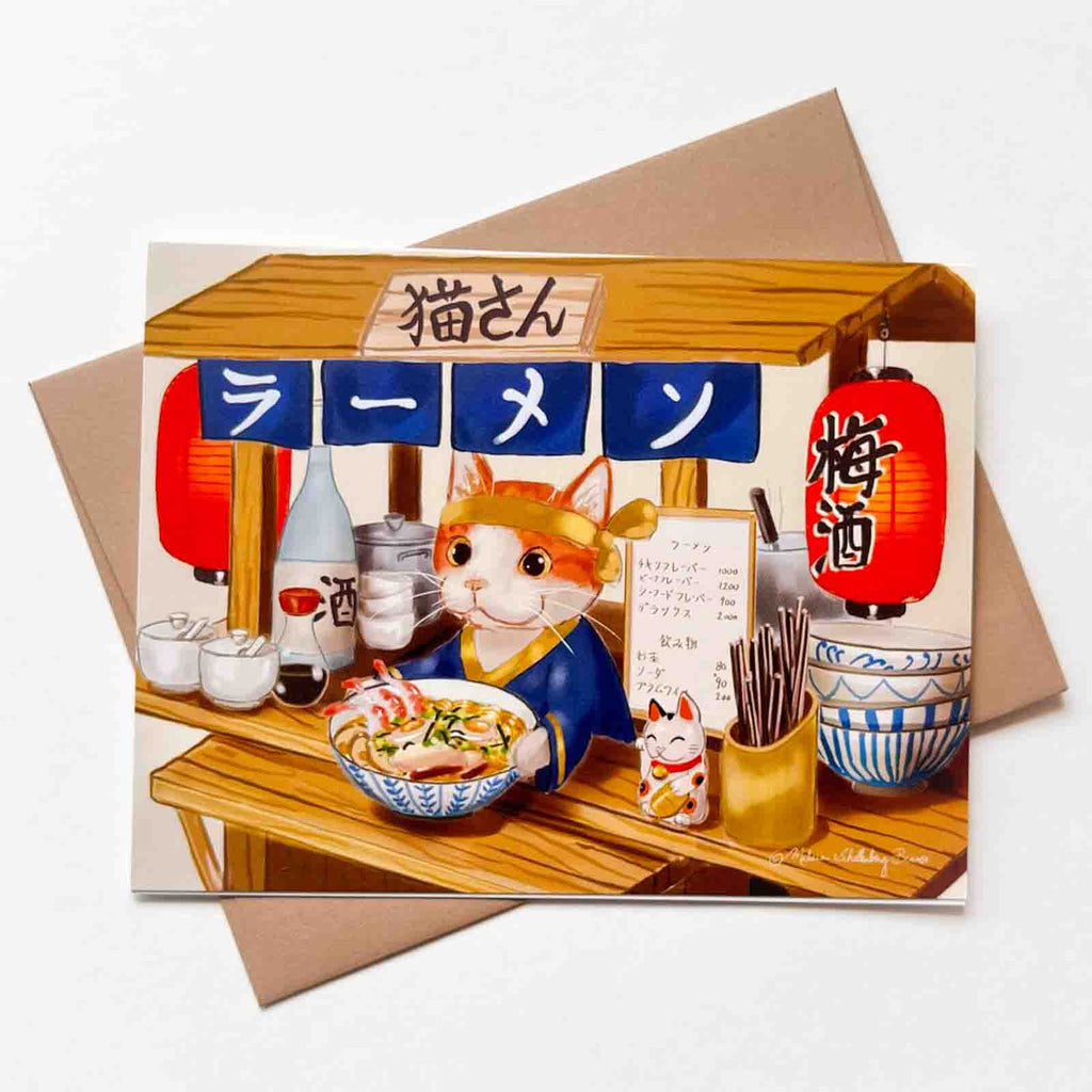 "Mr.Kitty's Ramen Shop" This vibrant greeting card features an orange cat selling ramen noodles out of a cart. 