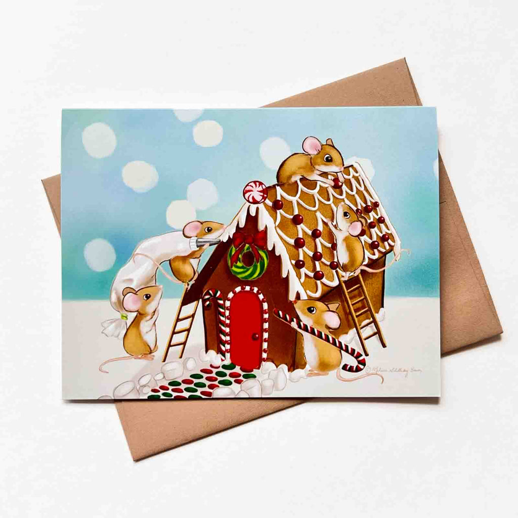 A festive holiday card featuring a group of mice building a gingerbread house. 