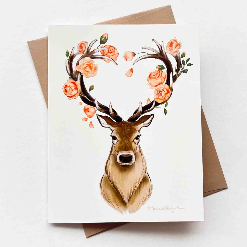 a love card featuring a majestic stag with heart shaped antlers surrounded by coral coloured roses. 