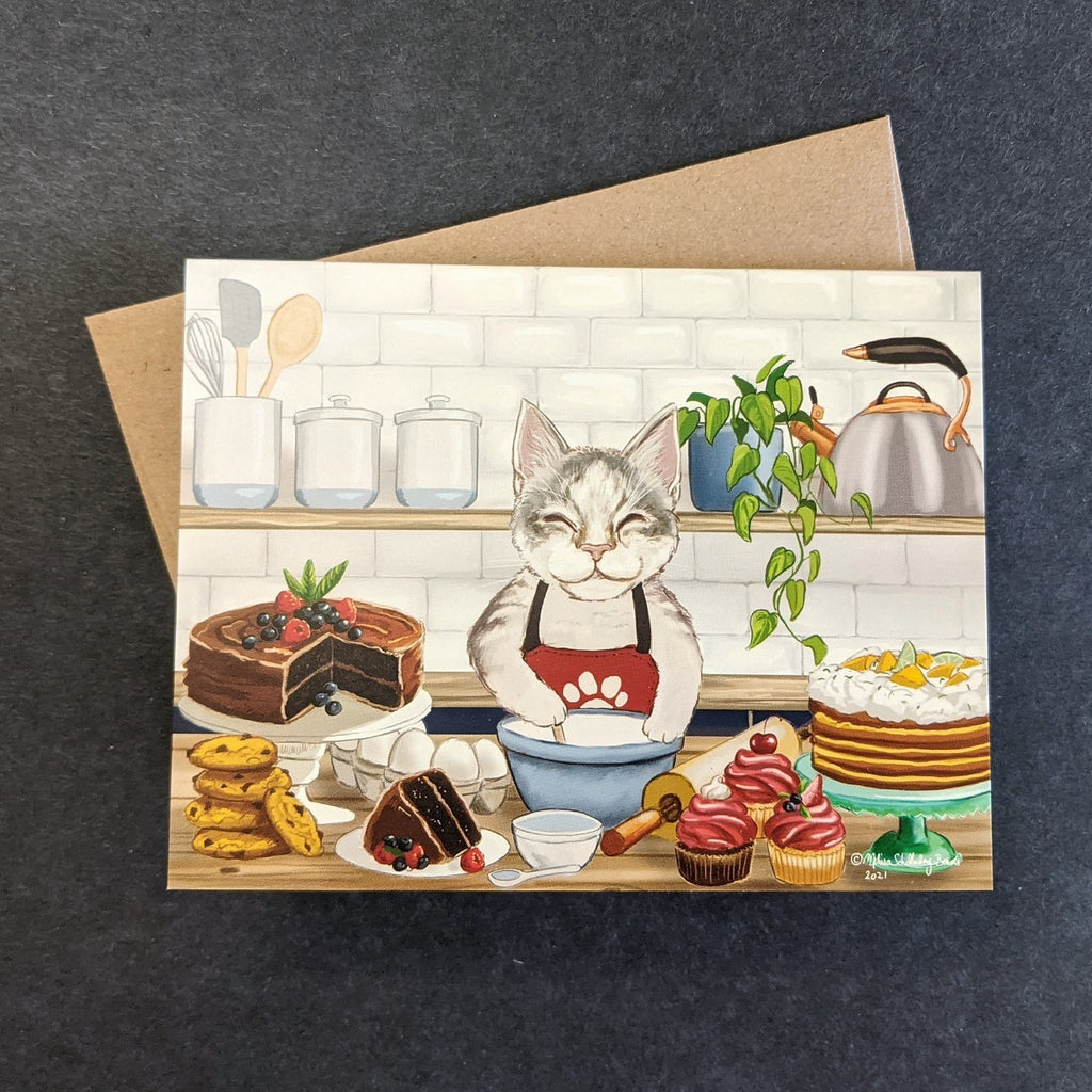 a whimsical notecard featuring a cat pastry chef in his kitchen, surrounded by cakes, desserts, and baked goods