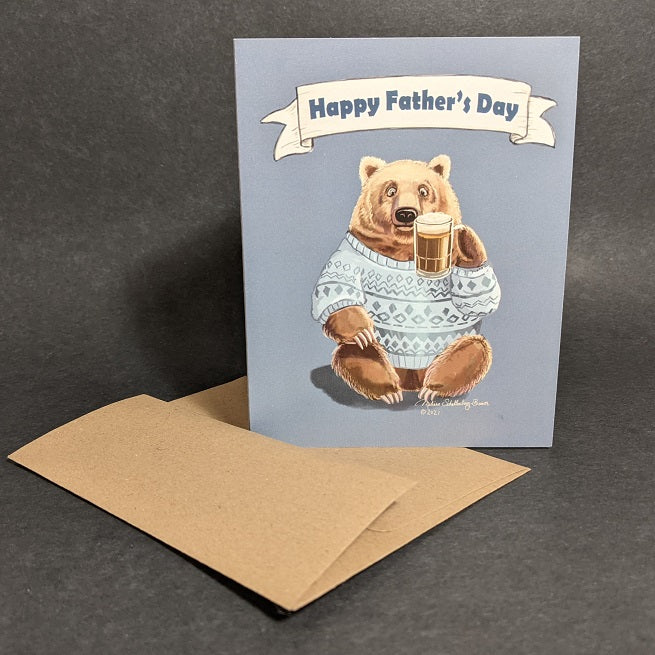 a greeting card a brown bear raising a mug of beer to say cheers