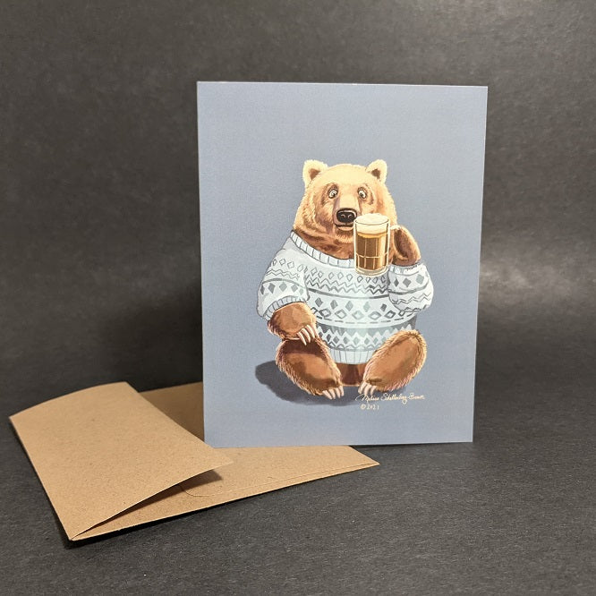 a greeting card featuring a brown bear raising a mug of beer to say cheers