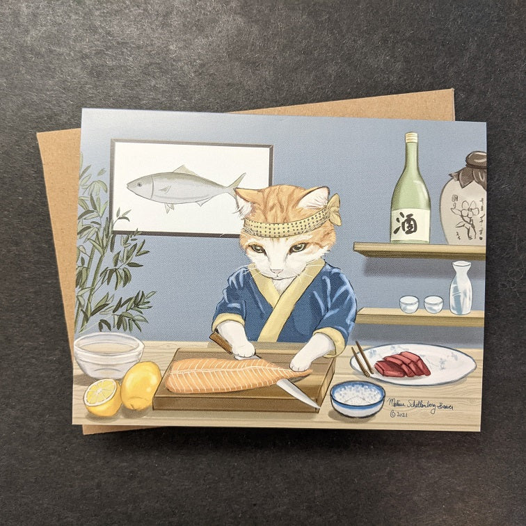 a notecard featuring a cat dressed as a sushi chef meticulously slicing sashimi