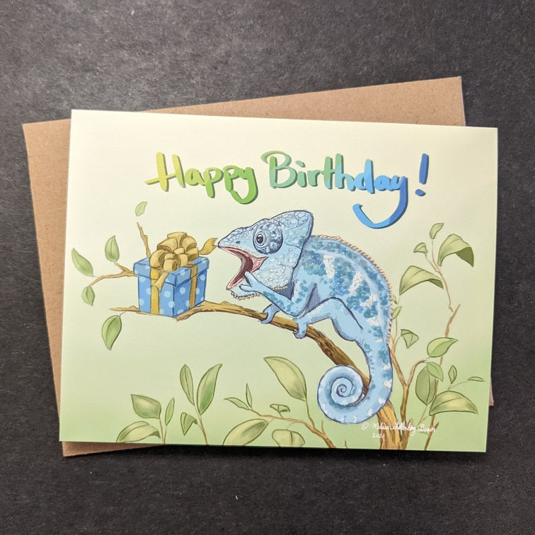 a birthday card featuring a chameleon delighted by his surprise birthday present