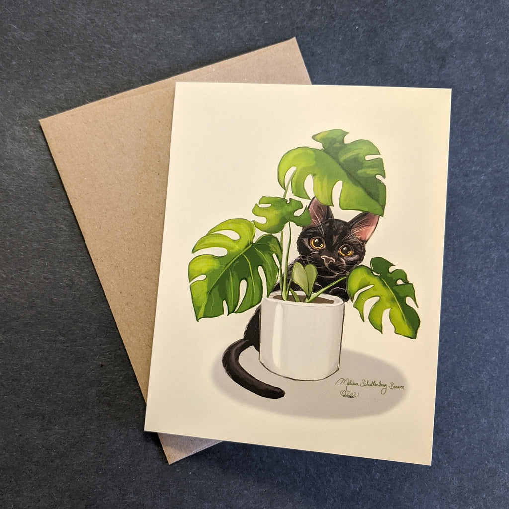 This blank notecard features a black cat peaking through a Monstera house plant