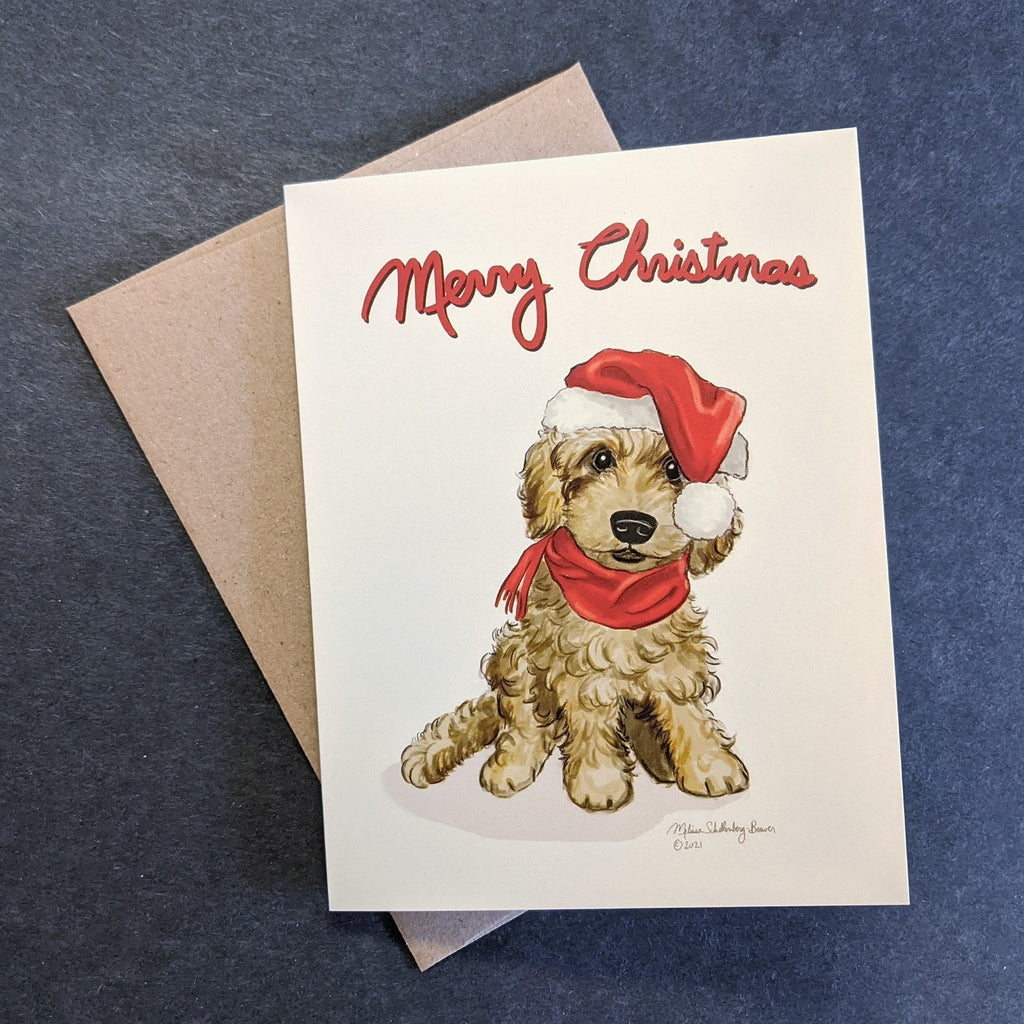 A cute goldendoodle wearing a red Santa hat is featured on this card. Matching brown envelope is shown