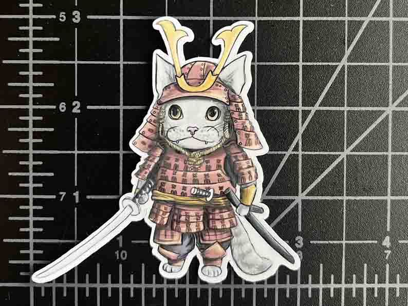 vinyl sticker featuring a stylized cat wearing Japanease Samurai warrior armour, holding a katana. size is 3 inches by 3 inches