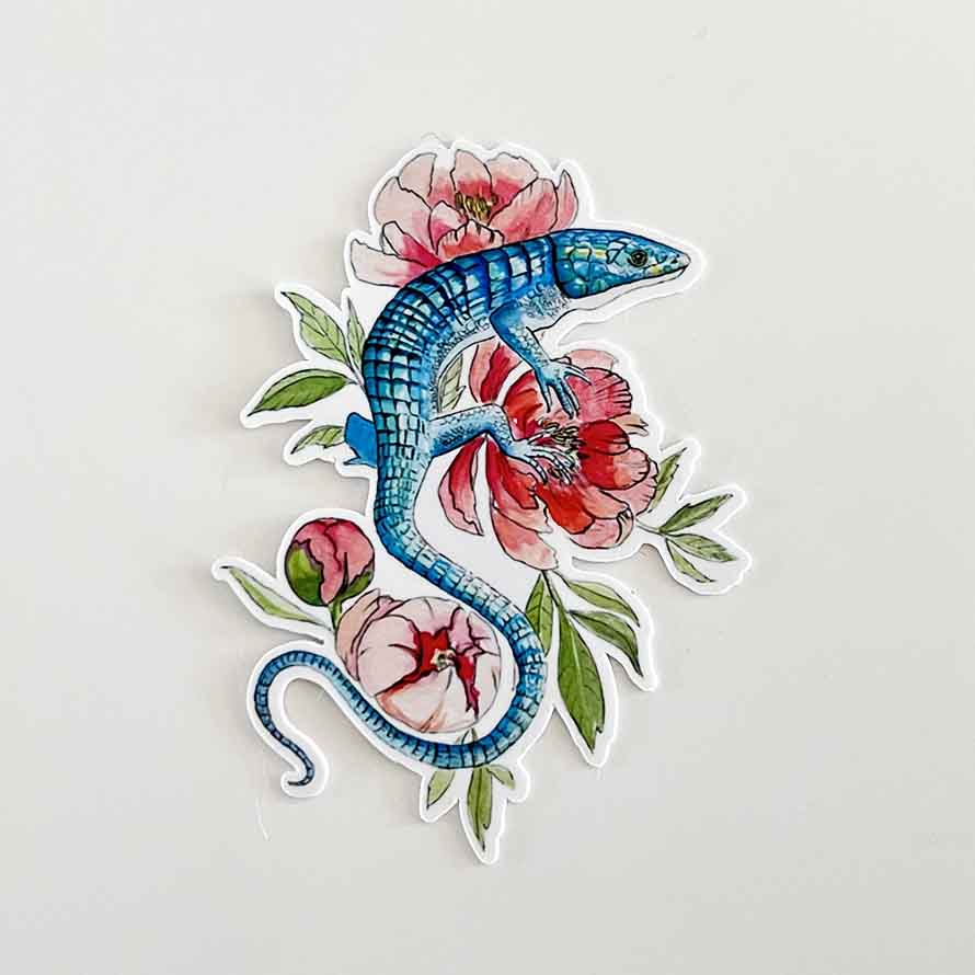 a 3 inch vinyl sticker of a abronia aka Mexican Alligator lizard resting on peony flowers