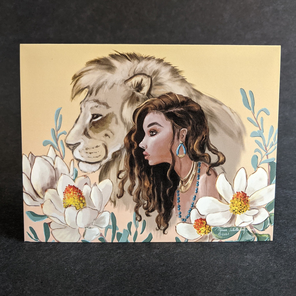 a beautiful notecard featuring a girl and her lion best friend surrounded by flowers